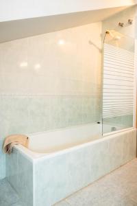 a bath tub in a bathroom with a window at Asturica in Astorga