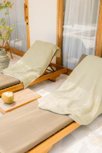 two beds are sitting in a room withermottermott at Turtle Villa 2 in Kuta Lombok