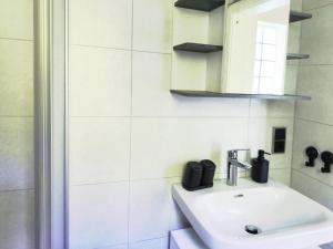 a bathroom with a sink and a mirror at Am Springelbach in Hinternah +14 photos