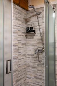 a bathroom with a shower with a glass door at Mon grenier in Aosta