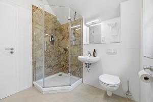 Un baño con ducha, inodoro y lavabo. en Dünenhäuser Ückeritz UnserUsedomDe FeWo ca50qm mit Parkplatz direkt am Strand 12I3, en Ückeritz 13 fotos más