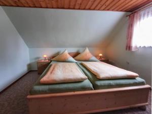 a bedroom with a bed with two pillows on it at Edith in Schwarzenbrunn