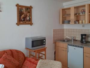 a kitchen with a couch and a microwave at Edith in Schwarzenbrunn