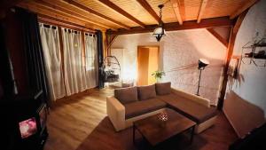 an overhead view of a living room with a couch at Maison au cœur du Val-de-Travers in Saint-Sulpice +1 photo