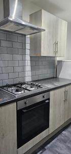 a kitchen with a stove and a stove top oven at Heywhyjas in Manchester