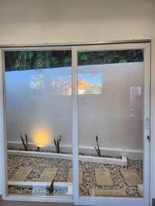 a room with a sliding glass door with plants at Bendesa Villa 14 in Ungasan +4 photos
