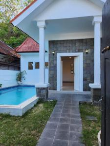 a house with a swimming pool in a yard at Bendesa Villa 14 in Ungasan