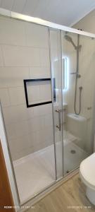 a shower with a glass door in a bathroom at Cabañas Limonares de Olmué in Olmué +16 photos