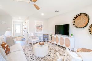 a living room with white furniture and a flat screen tv at BRAND NEW, fully furnished 3 bedroom, 3 bathroom home in Ocean Springs! in Gulf Hills +39 photos