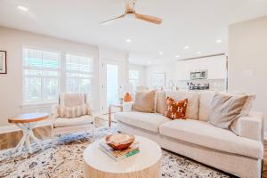 a living room with a couch and a table at BRAND NEW, fully furnished 3 bedroom, 3 bathroom home in Ocean Springs! in Gulf Hills