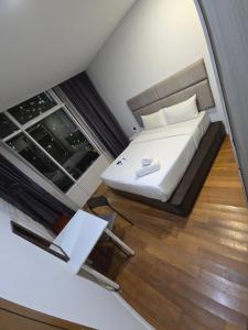 a small bedroom with a bed and a window at Vortex 3 bedroom Super service apartment klcc in Kuala Lumpur
