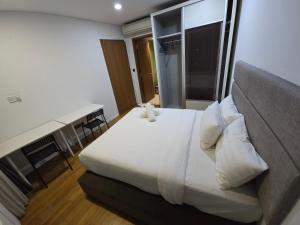 a bedroom with a large white bed and a window at Vortex 3 bedroom Super service apartment klcc in Kuala Lumpur