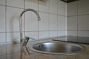 a sink in a kitchen with a faucet at Apartments Neda in Kampor +94 photos