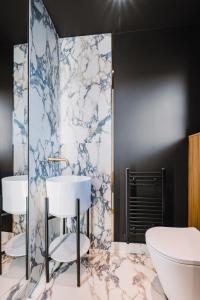 a bathroom with a white tub and a sink at JW Executive ApartHouse 2 in Glasgow +38 photos