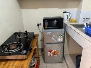 a small kitchen with a stove and a sink at Nzuri stays Embu in Embu