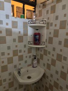 a bathroom with a sink and a soap dispenser at Nzuri stays Embu in Embu