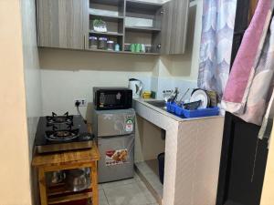 a small kitchen with a sink and a stove at Nzuri stays Embu in Embu