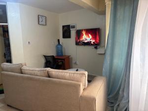 a living room with a couch and a tv at Nzuri stays Embu in Embu