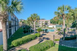 an aerial view of a resort with palm trees and a swimming pool at Cozy 2 bed 2 bath condo at the beachside Ocean Club Villas in Beauvoir