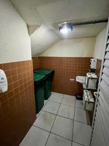 a small bathroom with a sink and a toilet at Apartamento Aconchegante Nogueira in Petrópolis