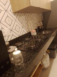 a kitchen counter with a stove top in a kitchen at Paraíso de porto in Porto De Galinhas