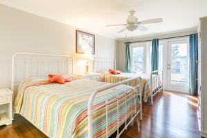 a bedroom with two beds and a ceiling fan at Cozy 2 bed 2 bath condo at the beachside Ocean Club Villas in Beauvoir