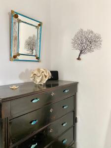 a dresser in a room with a mirror and a drawer at Cyclops House in Serifos Chora +34 photos