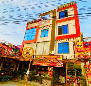 a building with a clock on the side of it at Hotel MAQ Lumbini in Lumbini