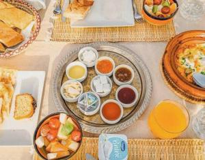 a table with many plates of food on it at Merzouga Standard Camp in Merzouga