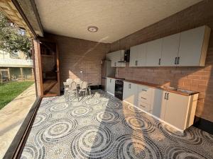 a kitchen with a mosaic floor in the middle at Ayvon Guesthouse in Samarkand