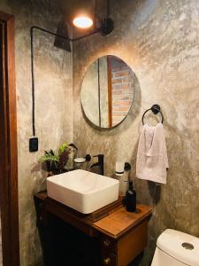 a bathroom with a white sink and a mirror at Cabaña Alua in Ferrería de Tula