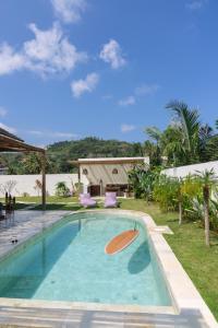 a swimming pool in the backyard of a house at Turtle Villa 2 in Kuta Lombok