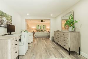 a living room with a couch and a mirror at Oleander Drive - Coquina Sands in Naples