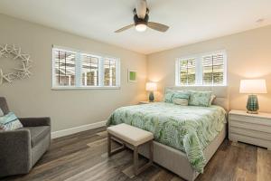 a bedroom with a bed and a ceiling fan at Oleander Drive - Coquina Sands in Naples +42 photos