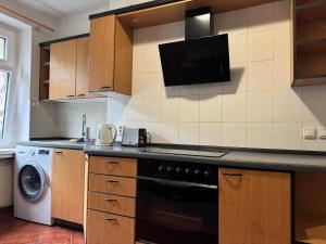 a kitchen with a stove and a microwave at Cozy Nest Eden- Apartment in Golčŭv Jeníkov +24 photos