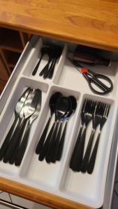 a white drawer filled with lots of utensils at Casa Bölts in Heltersberg +9 photos