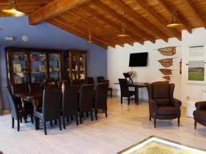 a dining room with chairs and a table and a tv at Casa de Trillo in Rego de Santa Marina