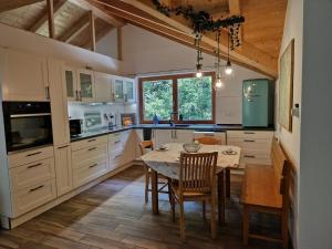 a kitchen with a table and a dining room at Waldbach-Oase in Thurmansbang