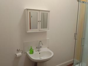 a bathroom with a sink and a cabinet at Executive Suite at Ideal home & cottage, Inviting 2 Bedroom apartment, Sleep 6 Ideal for contractors, family & Groups in Birmingham