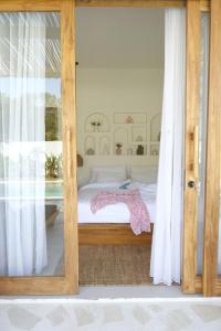 a bedroom with a bed and a glass door at Turtle Villa 2 in Kuta Lombok +34 photos