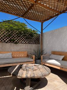 a patio with two couches and a table with at Nómadas Hostel in La Paz +47 photos
