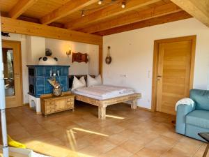 a room with a bed and a blue couch at Gipfelruhe Ramsau am Dachstein in Ramsau am Dachstein +33 photos