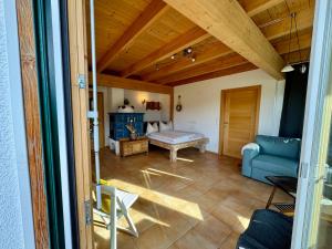 a living room with a blue couch and a table at Gipfelruhe Ramsau am Dachstein in Ramsau am Dachstein