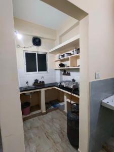 a kitchen with a desk and a window in a room at SriShivaShankari GuestHouse in Hyderabad