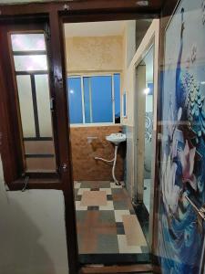 a bathroom with a window and a sink in a room at SriShivaShankari GuestHouse in Hyderabad