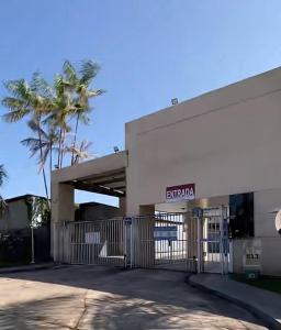 a building with a gate and a palm tree at Apartamento Belem Cop30 proximo ao aeroporto #belem #Cop 30 #aeroporto in Belém +14 photos