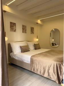 a bedroom with two beds and a mirror at Seraphia Apartment in Palermo