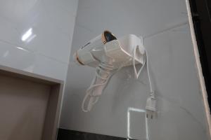 a white hair dryer hanging on a wall at Tam Coc Anna Villa in Ninh Binh