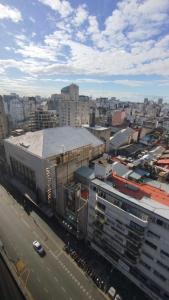 an aerial view of a city with buildings and a street at Torre Obelisco - Apart 2 Amb en Av Corrientes, Buenos Aires, Argentina in Buenos Aires