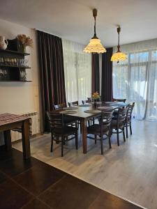 a dining room with a table and chairs at Бадевски рай- къща София in Veliko Tŭrnovo +27 photos